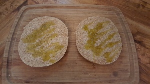 Drizzle of Robust Extra Virgin Olive Oil on Each Half of Pita Bread